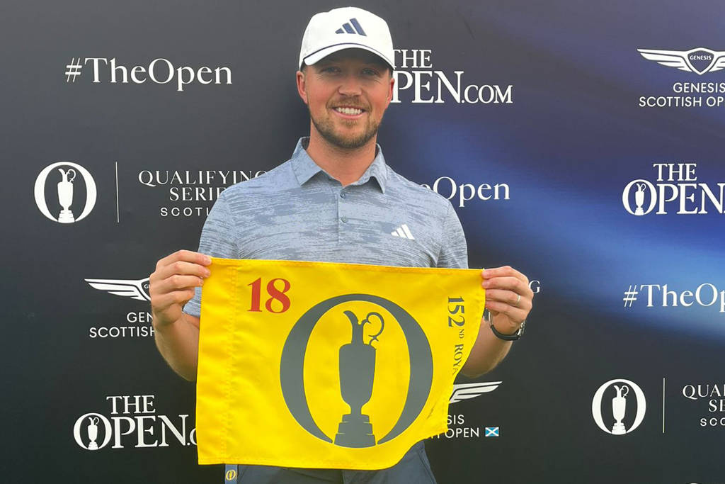 Richard Mansell poses with a Royal Troon pin flag after qualifying for The 152nd Open.